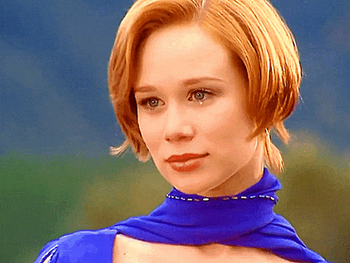 a close up of a woman wearing a blue scarf