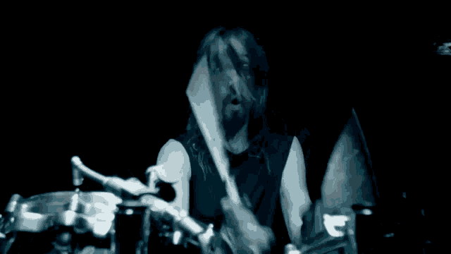 a person playing a drum set in the dark