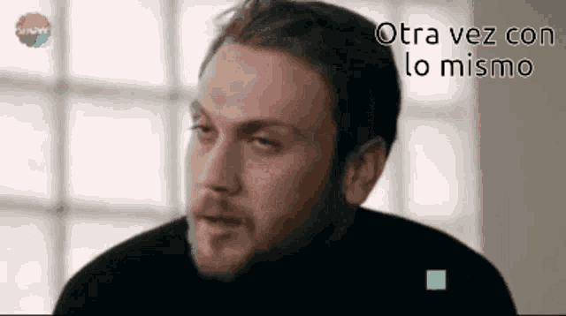 a close up of a man 's face with the words otra vez con lo mismo written in the corner .