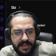 a man with a beard wearing headphones and glasses looks at the camera .