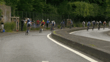 a group of cyclists are going down a road