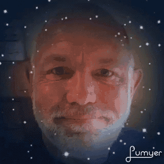 a close up of a man 's face with a beard and stars in the background .