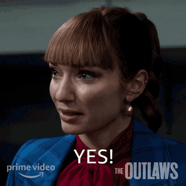 a woman wearing a blue jacket and a red shirt says " yes "