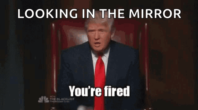 donald trump sitting in a chair giving the middle finger