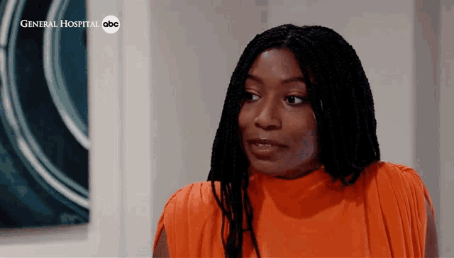 a woman in an orange dress is on a general hospital abc show