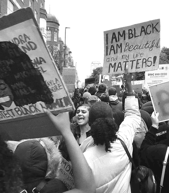 a group of people are holding up signs that say i am black i am beautiful and my life matters