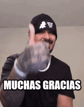 a man wearing a black beanie and a black shirt is giving a thumbs up sign ..