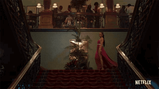 a woman in a pink dress is walking down a set of stairs with netflix written on the bottom