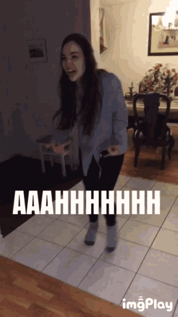 a woman is dancing in a room with the words aaahhhhhhh on the floor