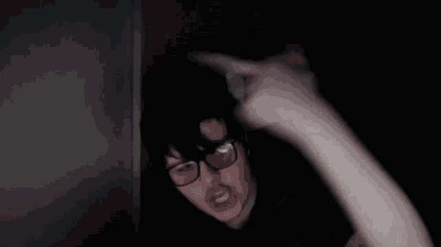 a blurry picture of a person 's face in the dark