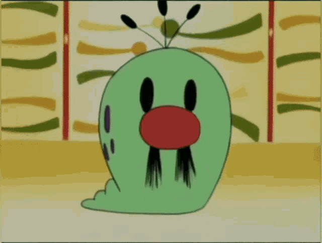a green cartoon character with a red nose and black eyebrows