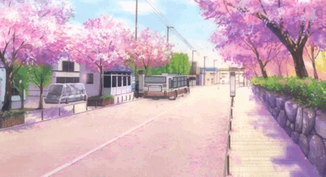 a bus is parked on the side of a road surrounded by cherry blossoms