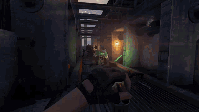 a person holding a gun in a video game with a green glowing object on it