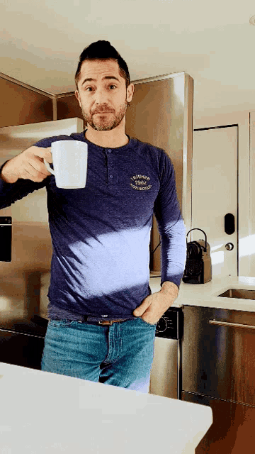 a man in a columbia shirt is holding a coffee cup