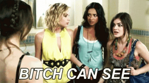 three women are standing next to each other in a bathroom and one of them is talking to another woman .