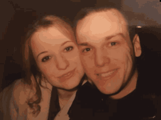 a man and a woman posing for a picture together