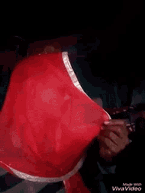 a man is wearing a red scarf around his head .