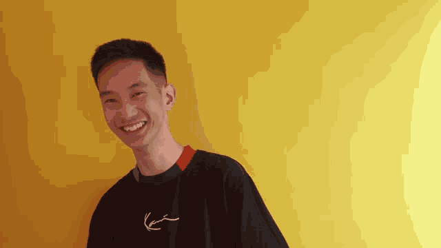 a man wearing a black shirt with karl kani written on it