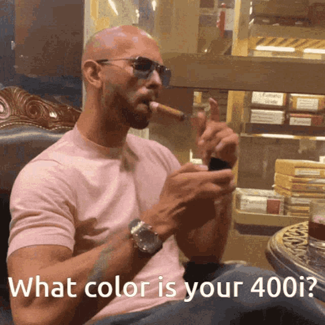 a man smoking a cigar with the words " what color is your 400i " next to him