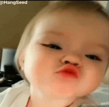a baby is making a funny face with his lips .