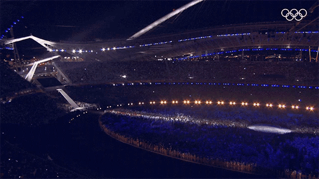a large stadium with the olympic rings on the top