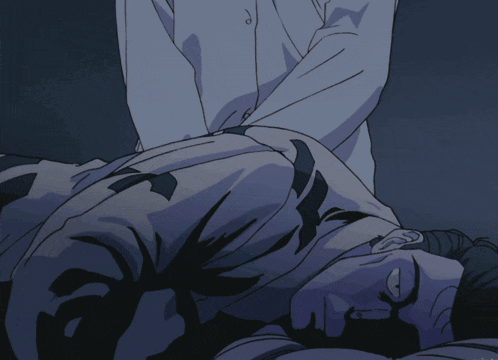 a man in a white shirt is laying on a bed