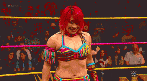 a woman in a wrestling ring with #wwe nxt written on the bottom