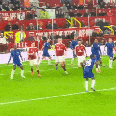 a group of soccer players on a field with a sign that says app now