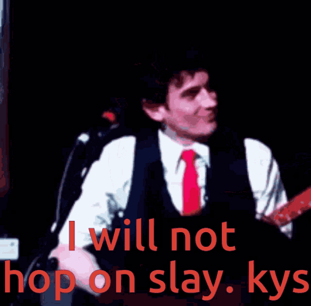 a man singing into a microphone with the words " i will not hop on slay kys " above him