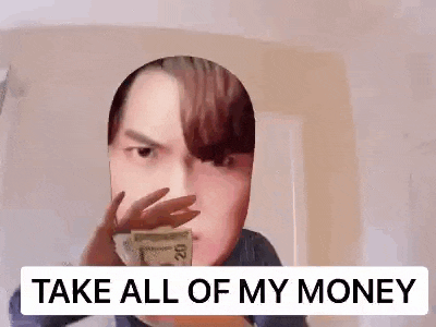 a man is holding a bunch of money in front of his face and saying `` take all of my money '' .