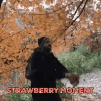 a man standing in the woods with the words " strawberry moment " written on the bottom