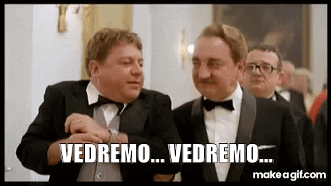 a group of men in tuxedos and bow ties are standing next to each other .