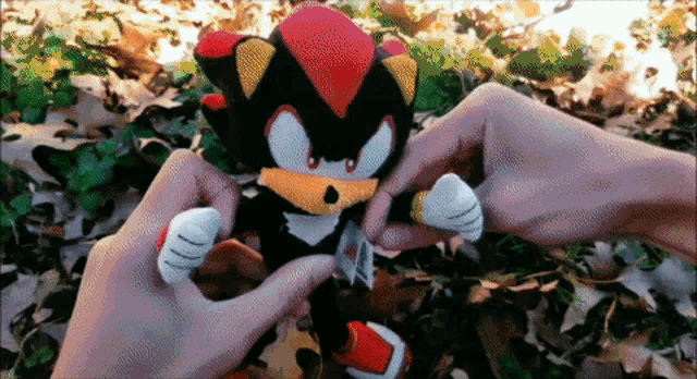 a person is holding a stuffed animal in their hands