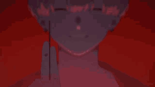 a close up of a person holding a purple object in front of their face .