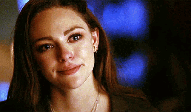 a close up of a woman 's face with a tear running down her cheek