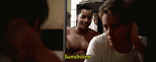 a man without a shirt is looking at himself in the mirror and says sunshine