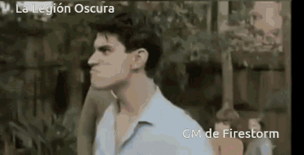 a man in a white shirt stands in front of a sign that says " la legion oscura "