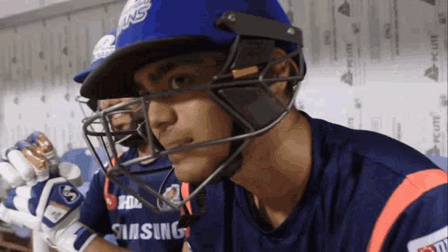 a man wearing a helmet and a samsung jersey