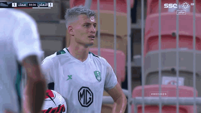 a soccer player wearing a green shirt with a md logo on it