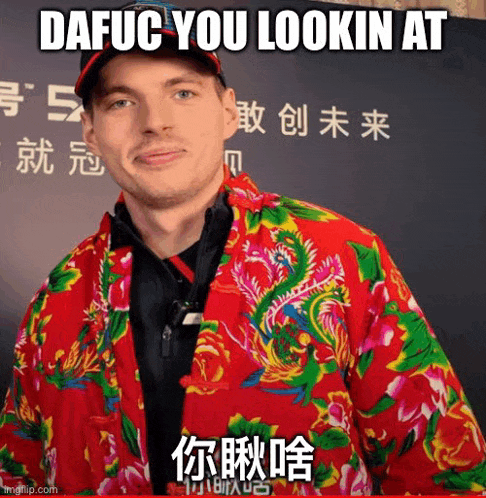 a man is wearing a colorful jacket with a dragon on it and a hat .