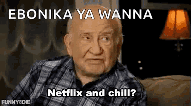 an elderly man in a plaid shirt is sitting on a couch with a lamp .
