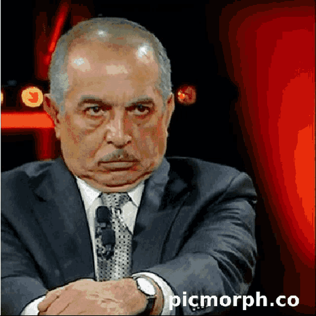 a picture of a man in a suit and tie with the website picmorph.co written below him