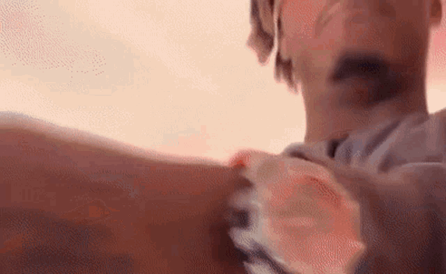 a close up of a person wearing a watch on their arm .