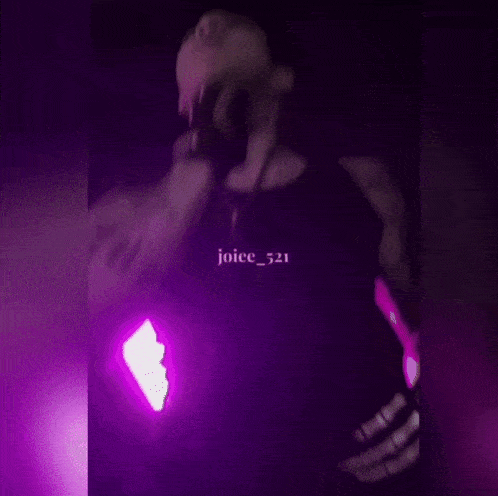 a man is standing in front of a purple light and the name joice_521 is on the bottom right