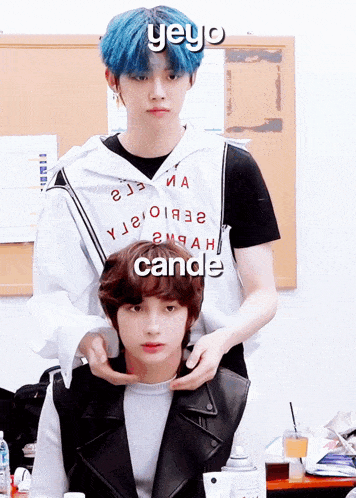 a boy with blue hair is standing next to another boy with black hair and the word yeyo on the top