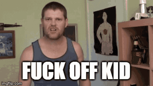 a man in a tank top is standing in front of a shelf with the words fuck off kid written on it .