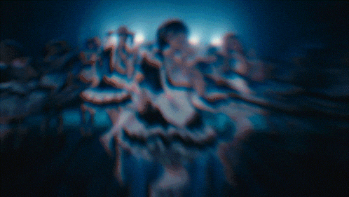 a blurred image of a group of people dancing
