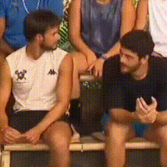 a group of people are sitting on a bench and one of them is wearing a kappa shirt