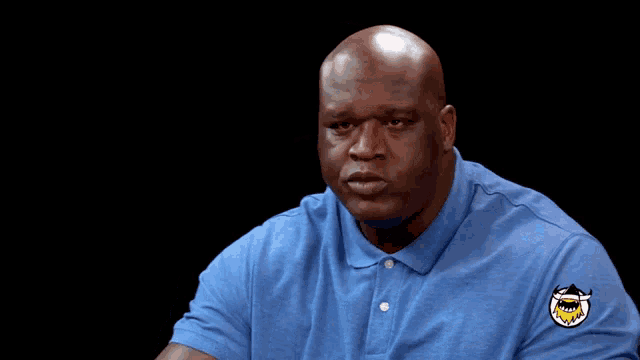 a bald man wearing a blue shirt with a patch that says " easy way to fail "