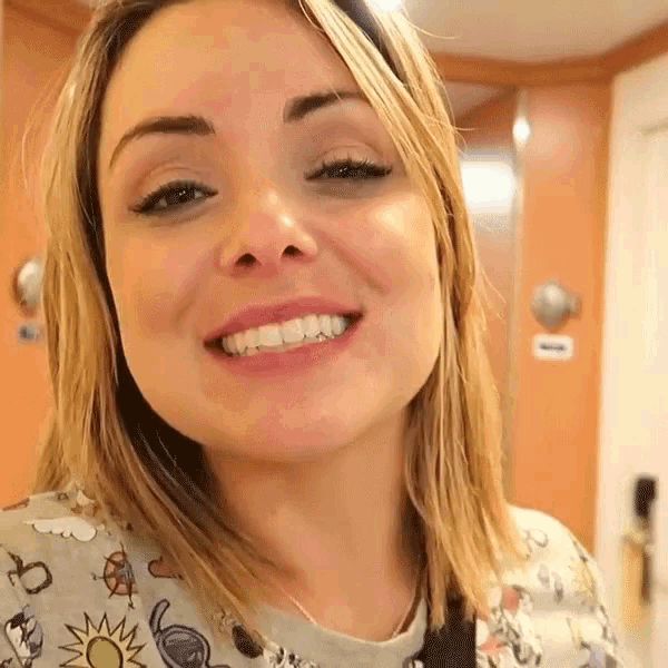 a close up of a woman 's face shows her teeth